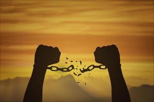 silhouette-hands-and-broken-chains-freedom-concept-photo